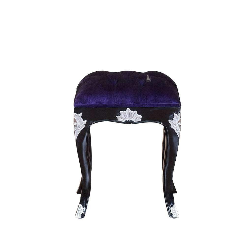 Seduce Stool by Haunt Cult, a compact stool with a deep purple tufted cushion, black curved legs and white carved accent details on the apron and feet