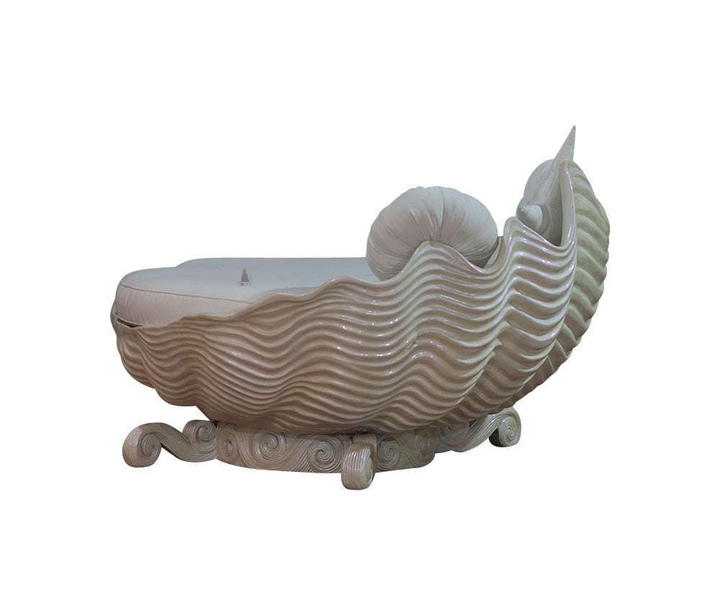 The Sirens Two Seater Love Seat, a handcrafted sculptural shell-shaped lounge with cushioned seating and curled base detailing.