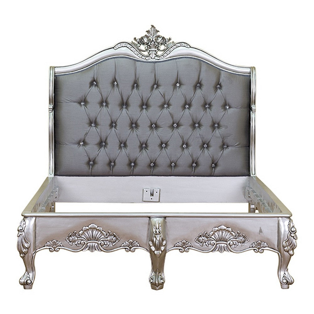 The Temptress Bed, a handcrafted French provincial-style bed with a tufted headboard, carved floral crest and elegant low footboard.