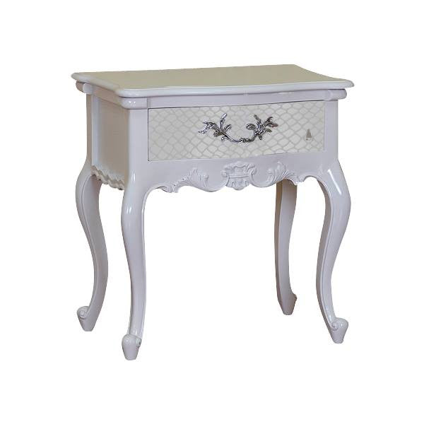 The Temptress Bedside Table, a handcrafted white bedside table with a textured drawer front, ornate metal handle and cabriole legs.
