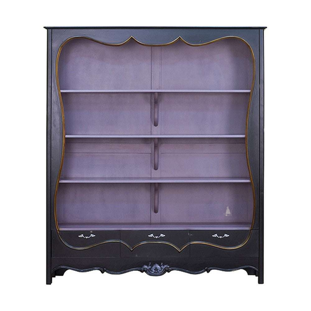 Vamp Couture Bookcase by Haunt Cult, a large black bookcase with a soft lavender interior, broad open shelves, gold-toned trim lines, lower drawers and a shaped decorative front opening