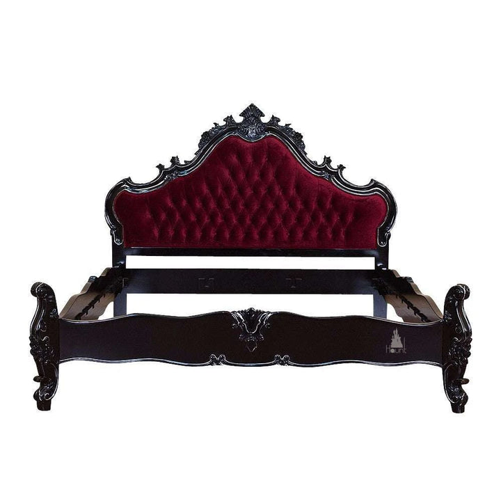 The Vampiress Bed, a handcrafted upholstered bed with a tall serpentine headboard, deep button tufting and carved gothic detailing.
