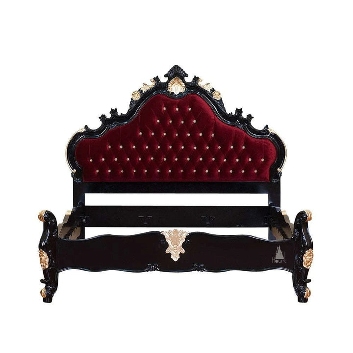 The Vampiress Bed, a handcrafted upholstered bed with a tall serpentine headboard, deep button tufting and carved gothic detailing.