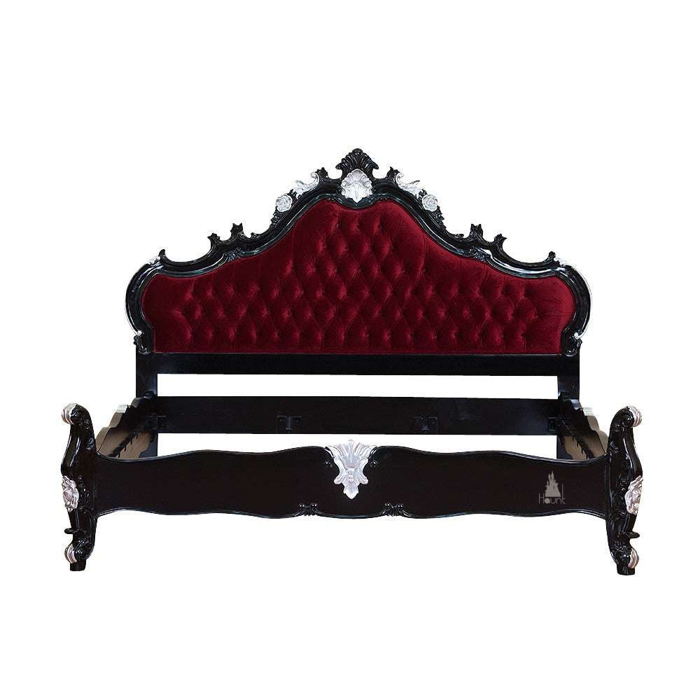 The Vampiress Bed, a handcrafted upholstered bed with a tall serpentine headboard, deep button tufting and carved gothic detailing.