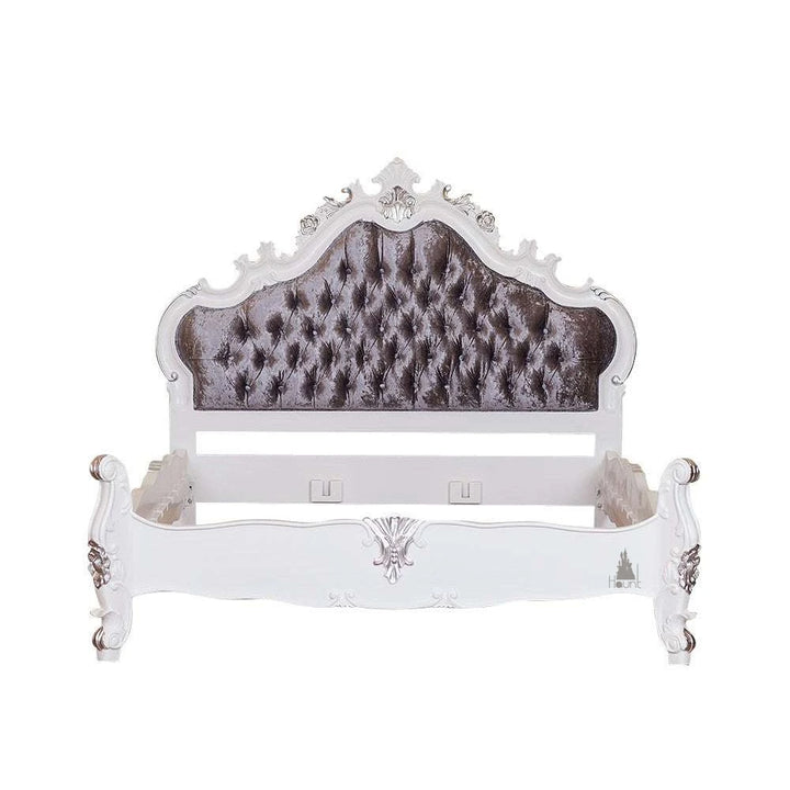 The Vampiress Bed, a handcrafted upholstered bed with a tall serpentine headboard, deep button tufting and carved gothic detailing.