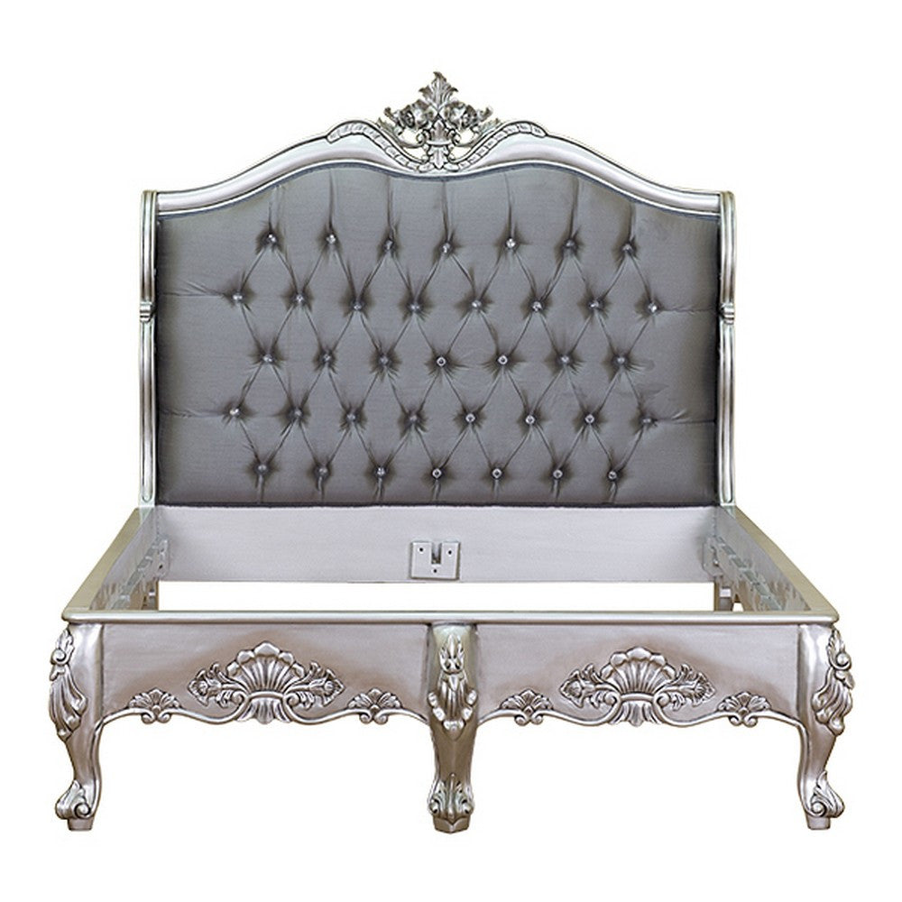 The Temptress Bed, a handcrafted French provincial-style bed with a tufted headboard, carved floral crest and elegant low footboard.